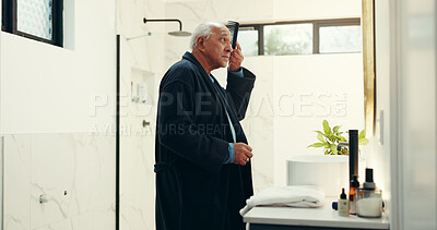 Buy stock photo Senior man, comb and brush hair in bathroom for beauty, healthy growth and grooming routine. Elderly person, mirror and cosmetic tools for scalp treatment, collagen benefits and texture glow at house