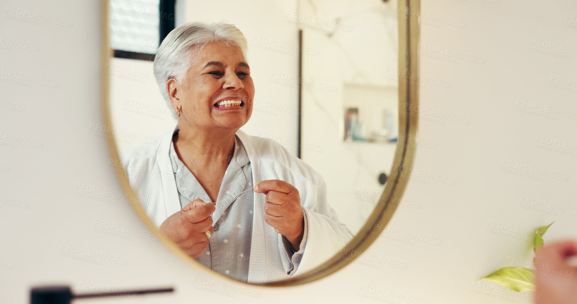 Buy stock photo Dental health, mirror and senior woman with flossing in bathroom for morning routine in home. Oral care, reflection and elderly female person with string for cleaning teeth with hygiene in apartment.