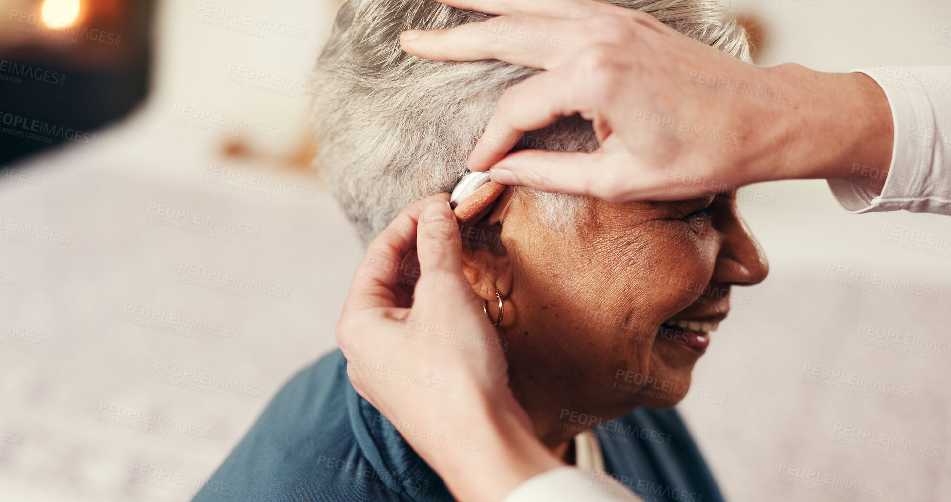Buy stock photo Hands, senior woman and hearing aid with nurse, smile or help with fitting in retirement home. Elderly person, caregiver and medical audio tech for patient with disability, deaf or implant in bedroom