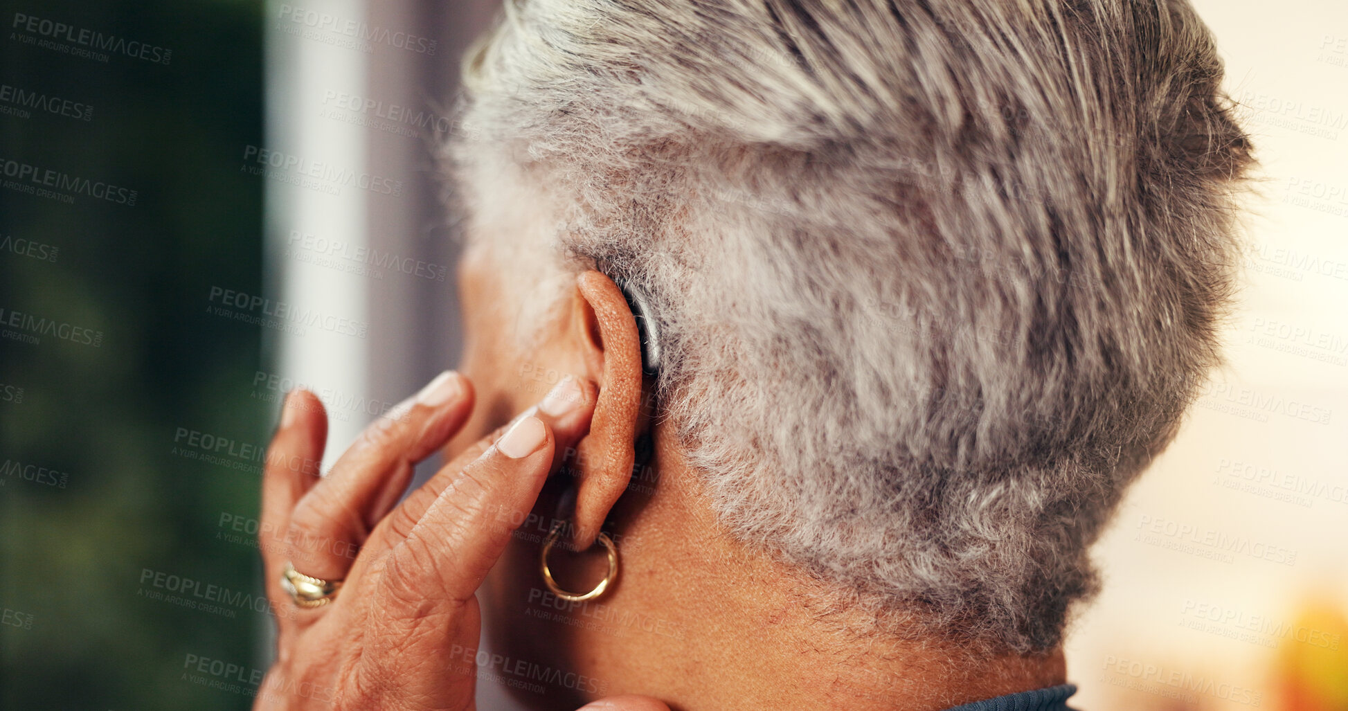 Buy stock photo Home, back and senior woman with hearing aid, testing and comfort with retirement. Hand, pensioner and elderly person with disability, medical audio tech and deaf with innovation and fitting mould