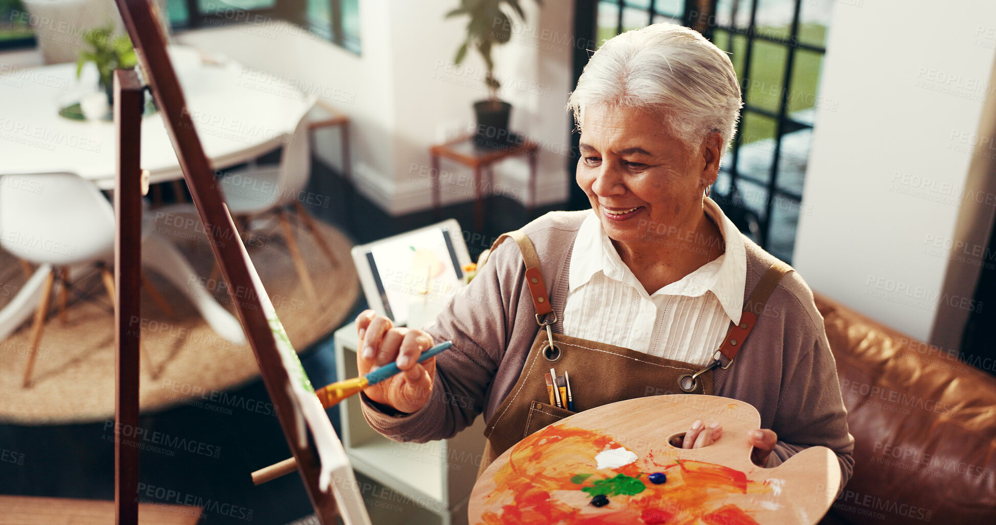 Buy stock photo Senior woman, painting and artwork in home with smile, above and canvas for inspiration in retirement. Elderly person, artist and happy with hobby, stroke or color for talent with creativity at house