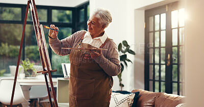Buy stock photo Senior woman, painting and happy in home with artwork, tools and canvas for inspiration in retirement. Elderly person, artist and smile with hobby, stroke and color with creative talent at house