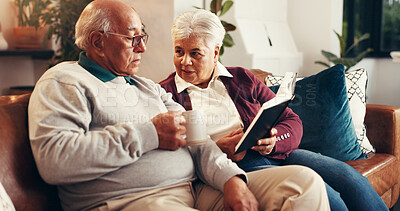 Buy stock photo Home, bible study and old couple on sofa, support and religion with relationship, worship and talking. Apartment, pensioner or senior man on couch, woman or holy scripture with spiritual guide or tea