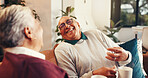 Elderly couple, coffee and laugh in home for love, joke and bonding together to relax. Tea, senior man and woman in living room with happiness, funny story and conversation with partner in retirement