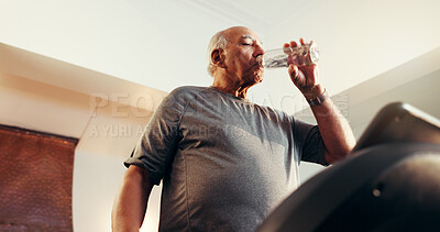 Buy stock photo Elderly man, fitness and water with treadmill in home for workout, exercise or hydration. Active, below or senior person drinking mineral liquid on running machine for cardio break, rest or recovery