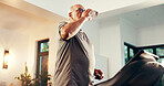 Senior man, fitness and water with treadmill in home for workout, exercise or hydration. Active, elderly or male person drinking mineral liquid on running machine for cardio break, rest or recovery