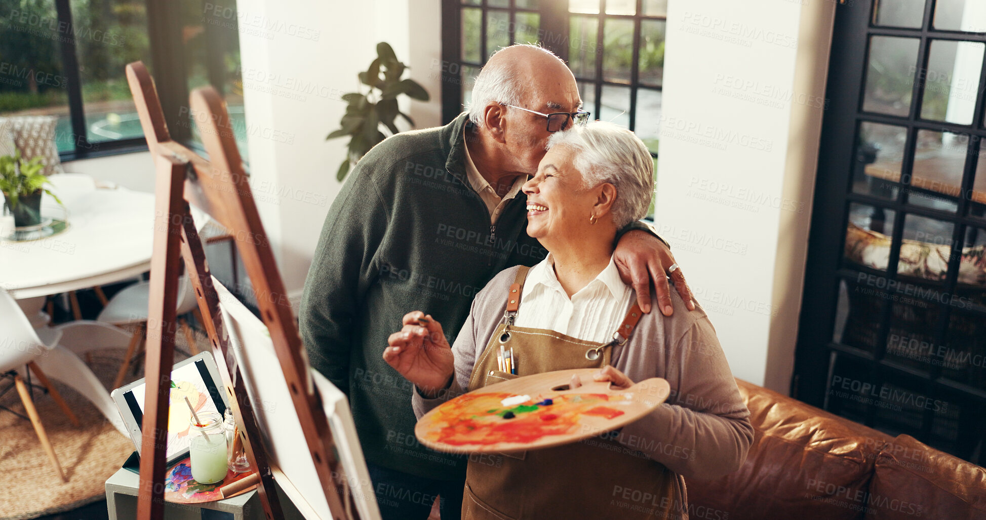 Buy stock photo Senior couple, kiss and painting on canvas for art, drawing sketch and bonding together. Above, elderly people and love of partner with craft artwork, creation and talent for retirement hobby in home