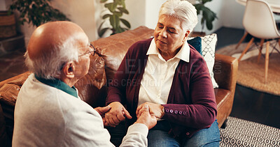Buy stock photo Praying, holding hands and trust with old couple on sofa for worship, gratitude and peace. Religion, spiritual connection and faith with people in living room of home for support, love and belief