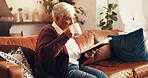 Senior woman, drink coffee and bible study on sofa in home with thinking, reflection and spiritual insight. Elderly person, tea and relax with holy scripture book, religion and faith in retirement