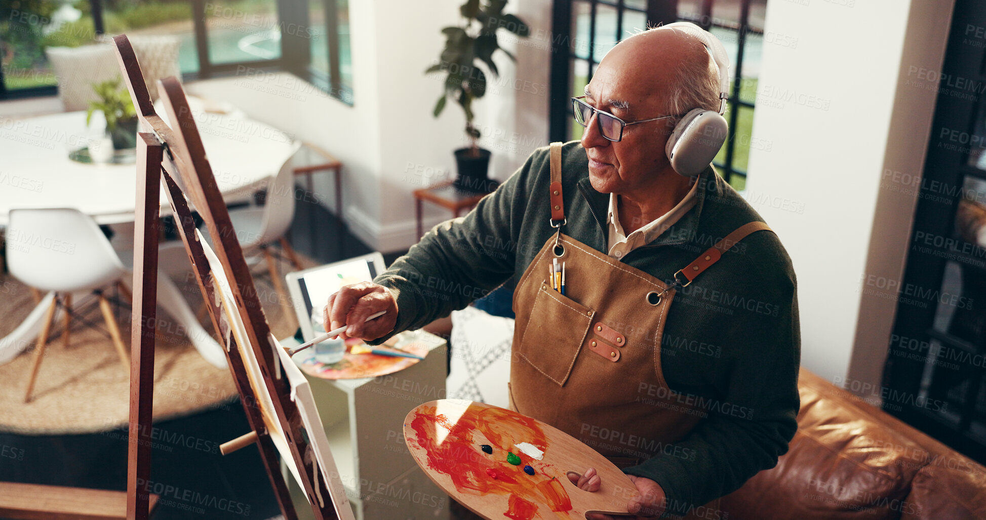 Buy stock photo Art, senior man and painting with headphones in home for creative activity, inspiration and canvas. Artist, above and old person with palette for retirement hobby, fine motor skills or audio playlist