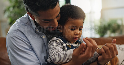 Buy stock photo Relax, holding hands and father with son on sofa for love, support and security together. Bonding, growth and child development with man and baby in living room of family home for trust and care