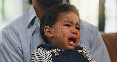 Buy stock photo Crying, comfort and dad with child on sofa with pain for teething, growing and development in home. Family, living room and father with upset, sad and frustrated baby for care, console and support