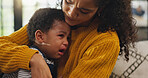 Crying, comfort and mom with child on sofa with pain for teething, growing and development in home. Family, living room and mother with upset, sad and frustrated baby for care, console and support