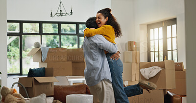 Buy stock photo Hug, success and moving with couple in new home for property, support and mortgage approval. Real estate investment, celebration and relocation with man and woman in living room for house purchase