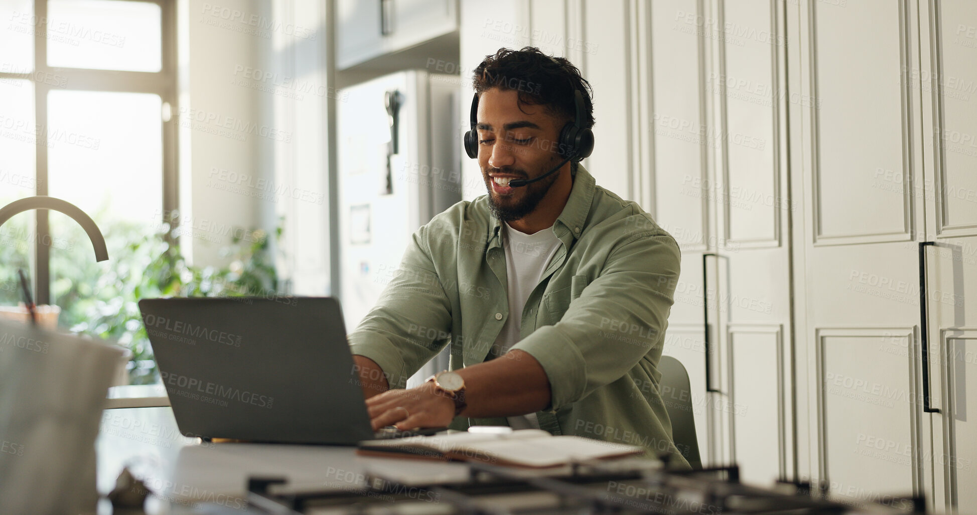 Buy stock photo Man, headset and laptop in kitchen for remote work, typing and advice for customer care call center. Technology, freelance help desk and consultant or virtual assistant for telecom support in home