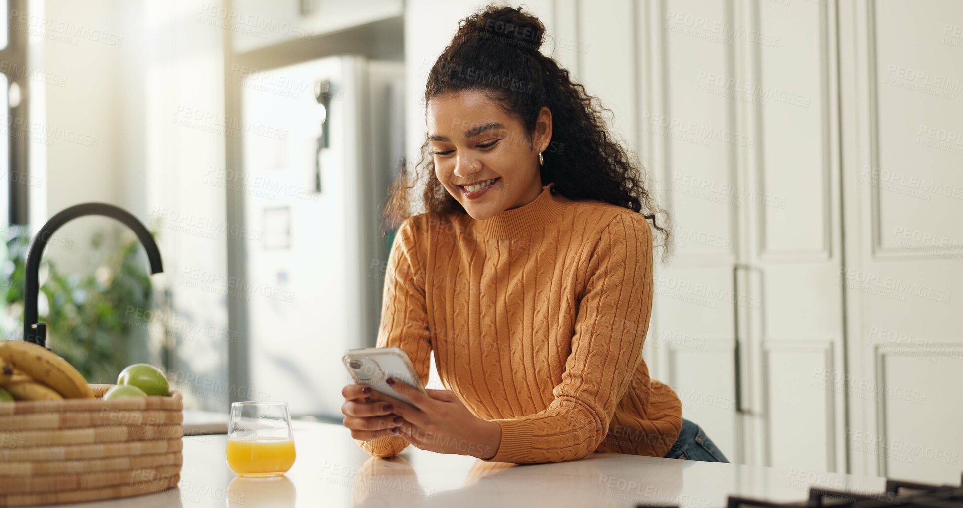 Buy stock photo Home, smile and woman in kitchen, smartphone and typing with social media, connection and texting. Apartment, orange juice and cellphone with communication, internet and message to contact and email