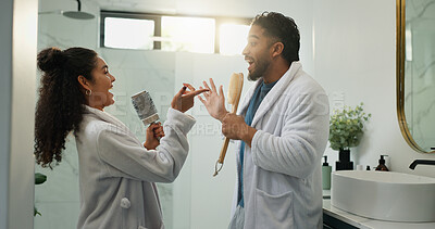 Buy stock photo Couple, singing and morning routine in bathroom with love, energy and excited for dancing. Music, man and woman in home with brush for celebration, karaoke rhythm and bonding with funny partner