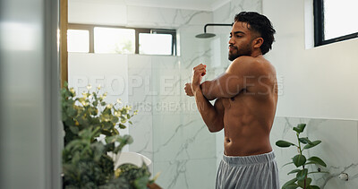 Buy stock photo Stretching, arm and mirror with man in bathroom for morning routine, workout transformation and health. Self care, bodybuilder pride and wellness with person in home for body and muscle progress