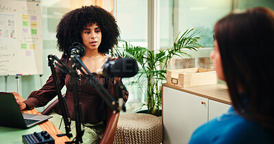 Buy stock photo Podcast, studio and women with mic talking for radio show, interview and broadcast subscription. Influencer, content creation and people on laptop for recording, conversation and host on live stream