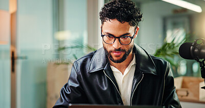 Buy stock photo Reading, online and man in studio for podcast, broadcast and talk show at media agency. Radio producer, content creation and person on digital tech for planning script, interview and notes for host