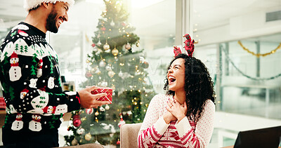 Buy stock photo Christmas, gift and business people with surprise in office for holiday, tradition and celebration. Professional, friends and man giving present to woman for festive season, xmas party and gratitude