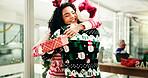 Christmas, gift and business people hug in office for holiday, tradition and celebration. Professional, friends and man giving present to woman for festive season, xmas party or embrace for gratitude