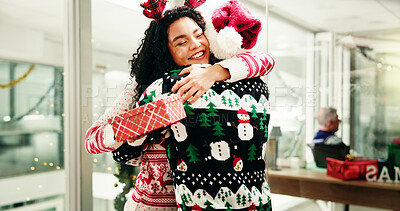 Buy stock photo Christmas, gift and business people hug in office for holiday, tradition and celebration. Professional, friends and man giving present to woman for festive season, xmas party or embrace for gratitude