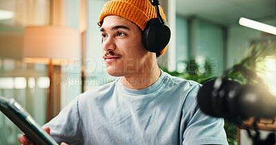 Buy stock photo Thinking, tablet and man in studio for podcast, broadcast and talk show at media agency. Radio producer, content creation and person on digital tech for planning script, interview and notes for host