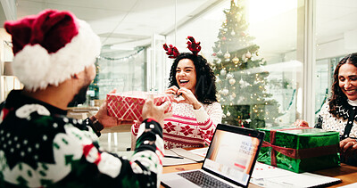 Buy stock photo Christmas, gift and heart hands with business people in office together for celebration or party. Present, smile and thank you with employee team in workplace for festive surprise or tradition