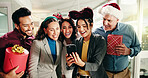 Christmas, notification and phone with excited business people in office together for sharing news. Announcement, app and collaboration with happy employee team in workplace for festive alert
