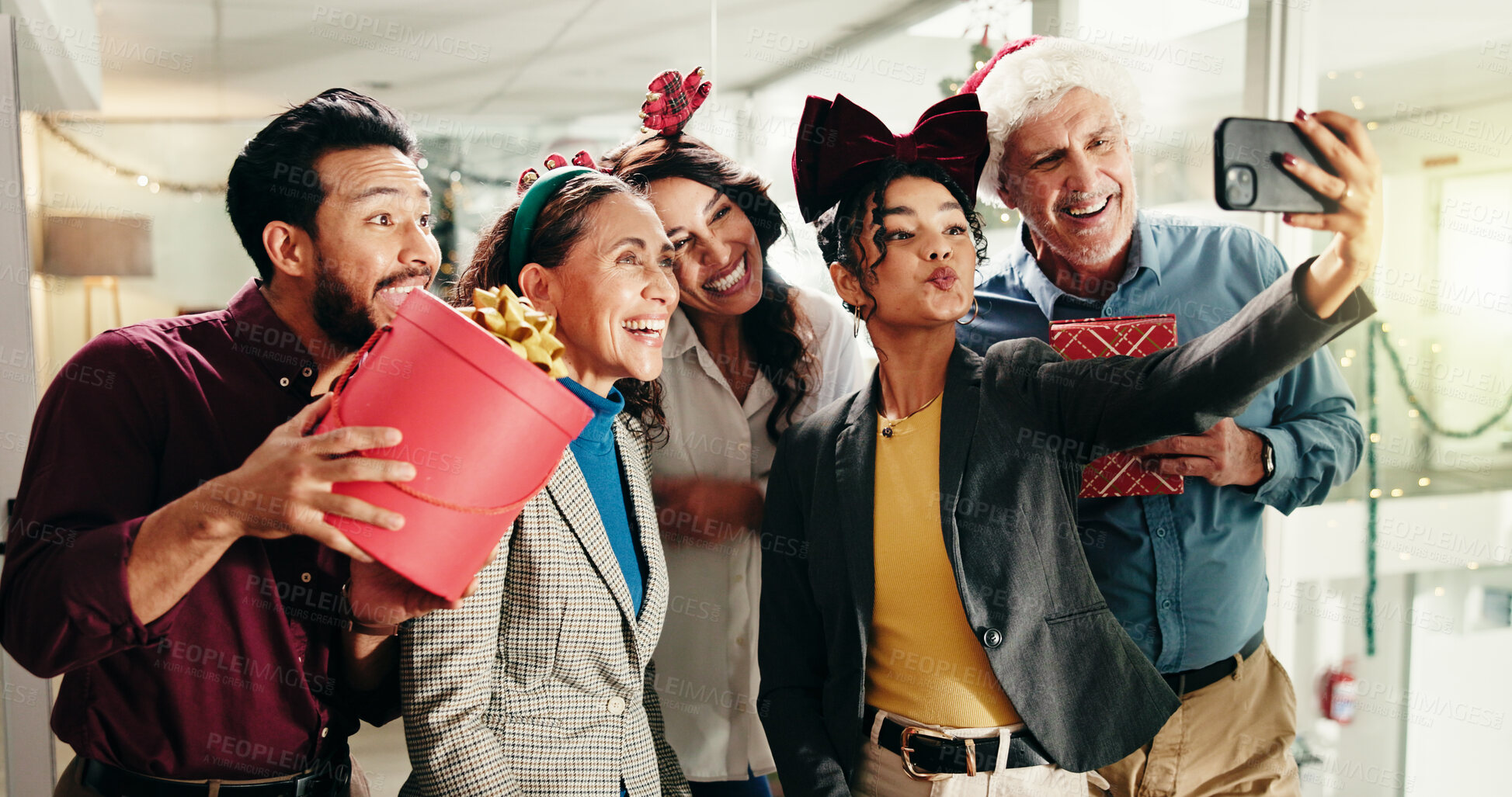 Buy stock photo Christmas, business people and group selfie in office for funny photography with gift. Xmas picture, friends and happy workers with holiday spirit, December celebration or social media post at party
