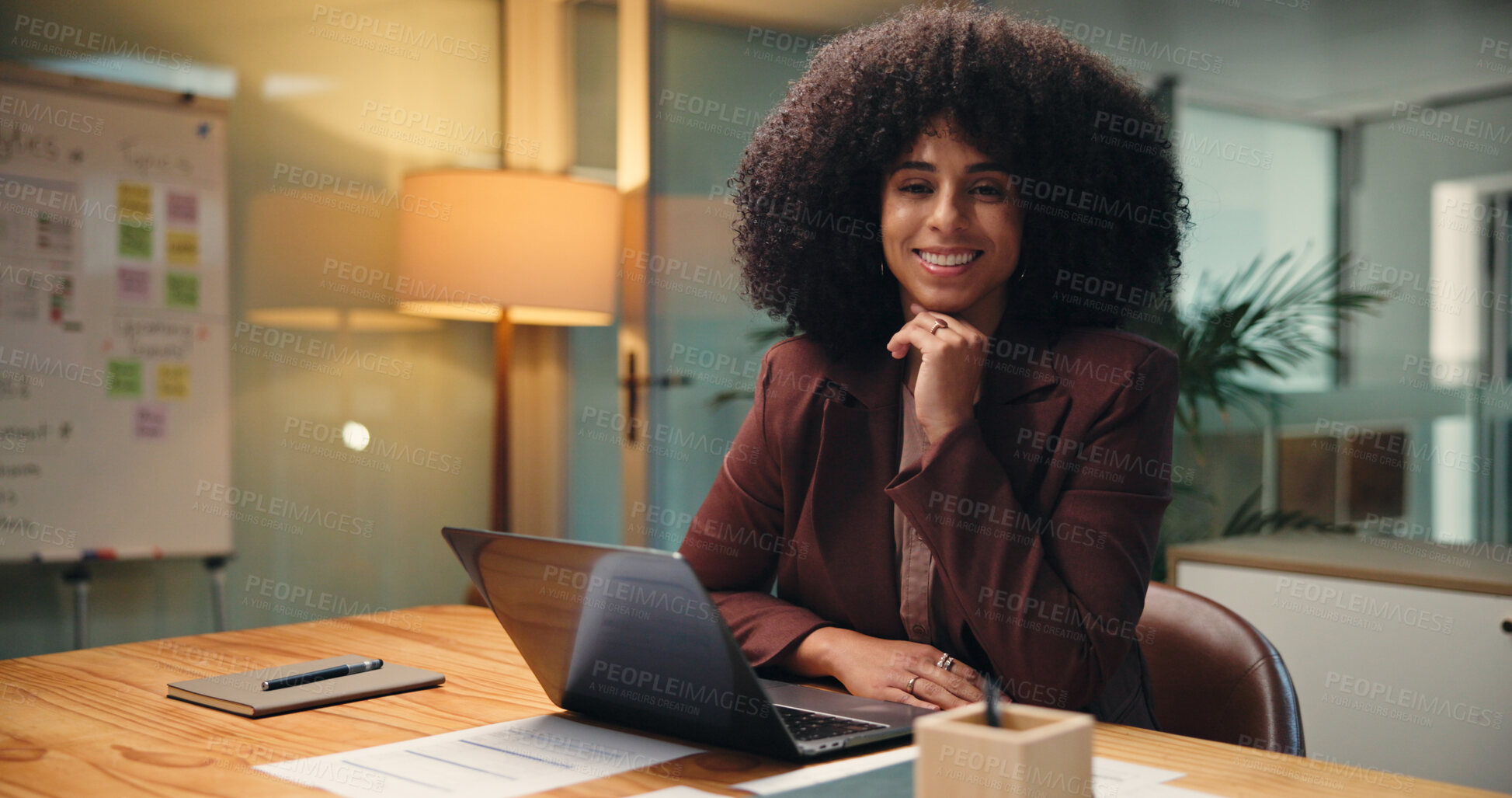 Buy stock photo Laptop, night and portrait with business woman in office for finance, investment or report deadline. Accounting, computer and financial review with smile of happy African employee at workplace desk