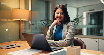 Buy stock photo Development, laptop and portrait of business woman in office at night for social media analytics. Computer, smile and statistics with happy Indian employee at desk in workplace for evening deadline