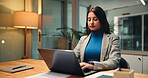 Laptop, night and typing with business woman in office for finance, investment or report deadline. Accounting, computer and financial review with Indian employee at desk in workplace for planning