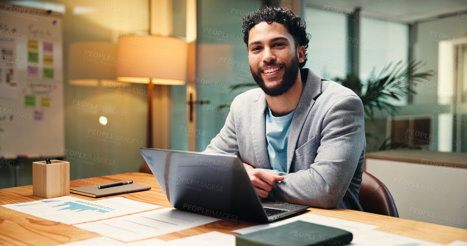 Buy stock photo Laptop, portrait and smile of business man in office at night for social media statistics. Computer, evening and happy with employee at desk in workplace for digital platform, analytics or review