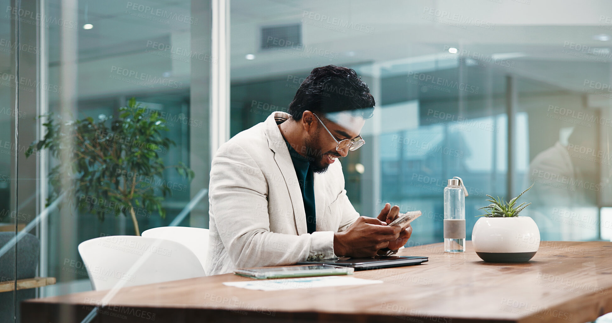 Buy stock photo Businessman, phone and texting at office for finance career at night, smile and done with project. Person, smartphone and broker on mobile app, notification or overtime with social media at agency