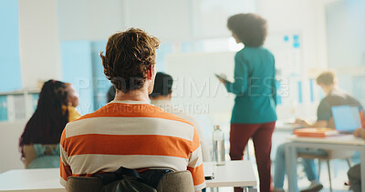 Buy stock photo Man, student and back view with teacher in classroom for learning or higher education in university. Male person, academic or learner with educator for knowledge, development or growth in college