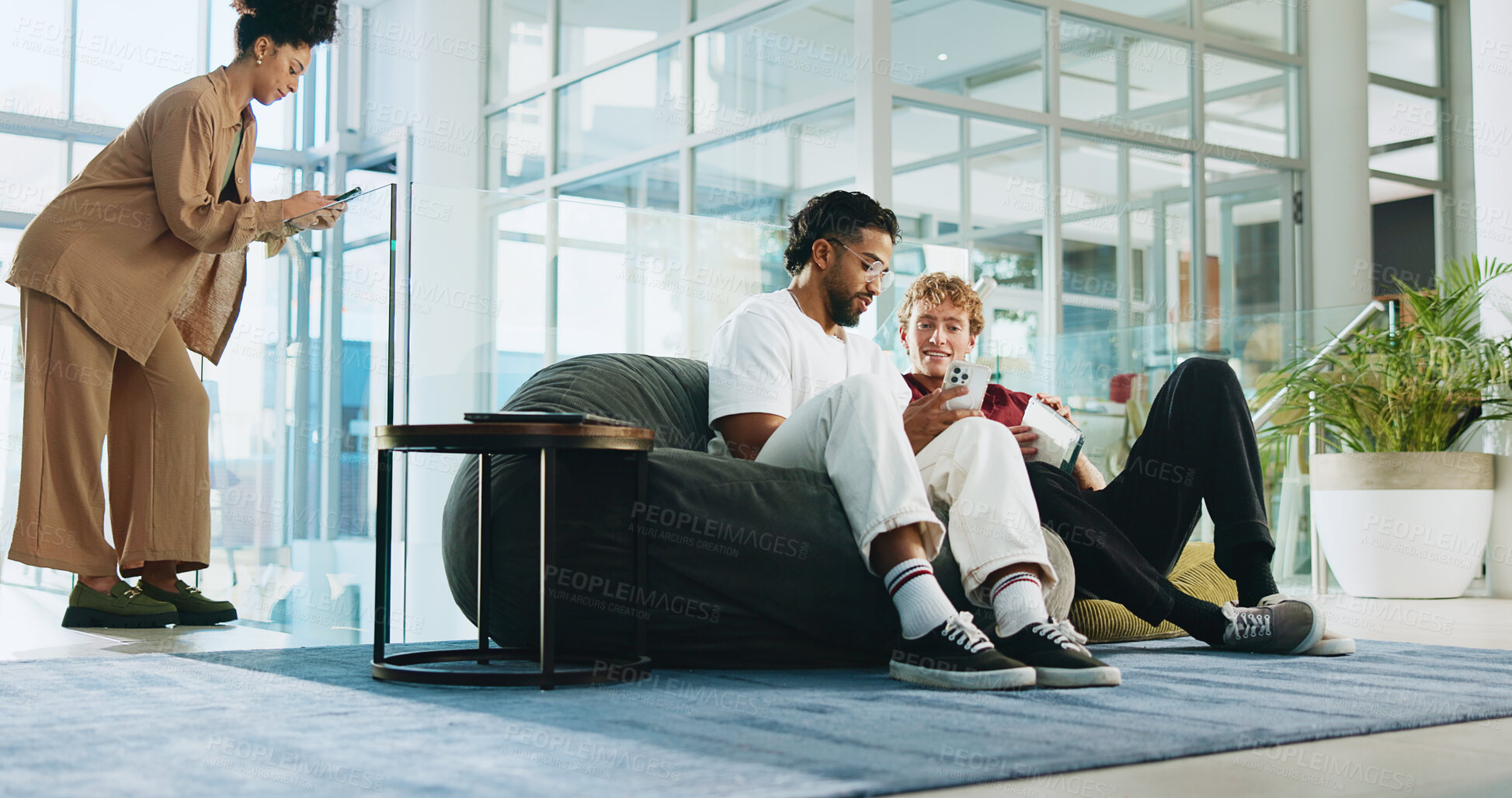Buy stock photo Men, students and friends with phone for college, schedule and chat on lobby beanbag. People, smartphone and talk with mobile app, relax and social media post for university announcement or learning