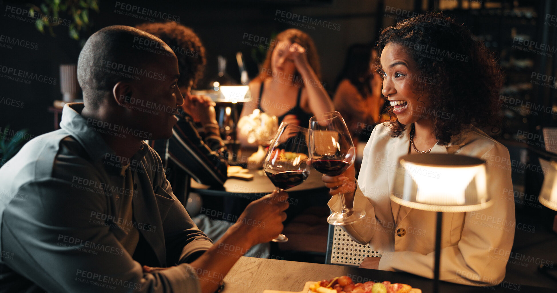 Buy stock photo Happy couple, wine glass and toast on date at restaurant with partner, smile and relationship goals. African woman, man and alcohol beverage with celebration, excited and romantic night with drink