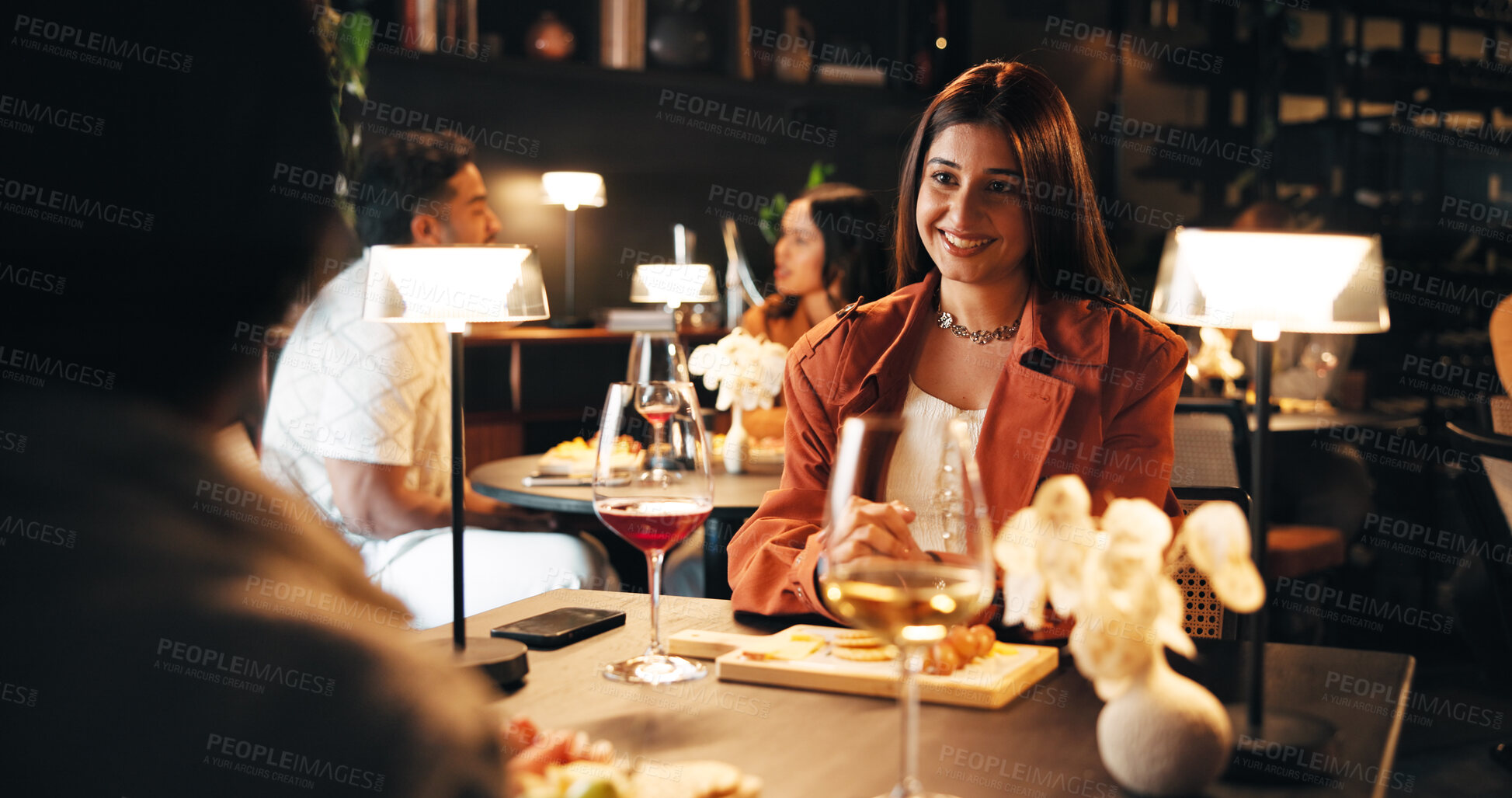 Buy stock photo Smile, date and relax with woman in restaurant for romantic anniversary, bonding and fine dining chat. Connection, love and marriage commitment with couple at night for dinner reservation and support