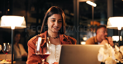 Buy stock photo Laptop, wine and woman in restaurant at night with online blog for hospitality review with freelance. Remote work, drink and female author with computer for writing book chapter at luxury cafe.