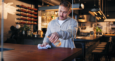 Buy stock photo Pub, bartender and spray bottle with cloth for hygiene, dust and service for drinks at restaurant. Man, owner and check for dirt with cleaning, shine and career with inspection at small business