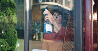Buy stock photo Man, owner and cleaning with window in cafe for detergence, disinfectant or preparation. Male person, barista or bottle with glass, spray or chemical for dirt, bacteria or germ removal in coffee shop