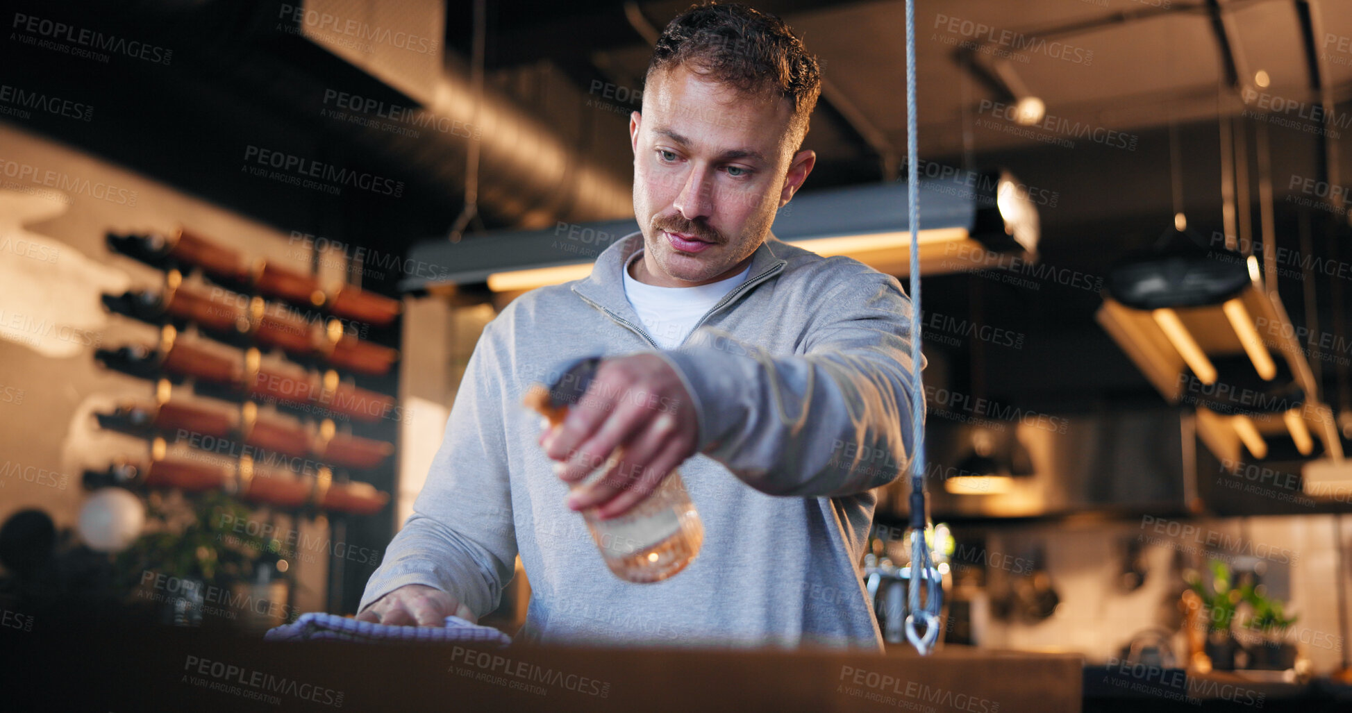 Buy stock photo Man, bartender and cleaning with counter in coffee shop for detergence, disinfectant or preparation. Male person, cleaner or bottle with spray or chemical for dirt, bacteria or germ removal in cafe