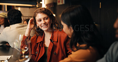 Buy stock photo Talking, friends and women in bar, smile or bonding on night out, discussion and alcohol on weekend. Happy, people and conversation on break in pub, evening and together with beverage and liquor