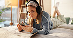 Phone, bed and woman with headphones in home for relaxing, writing in journal and social media. Bedroom, happy and person listening to audio, radio and streaming music for inspiration in morning