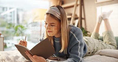 Buy stock photo Woman, happy or writing in notebook on bed for article inspiration, plot development or remote work. Freelancer, writer and smile with diary in home for journal entry, project to do list and planning