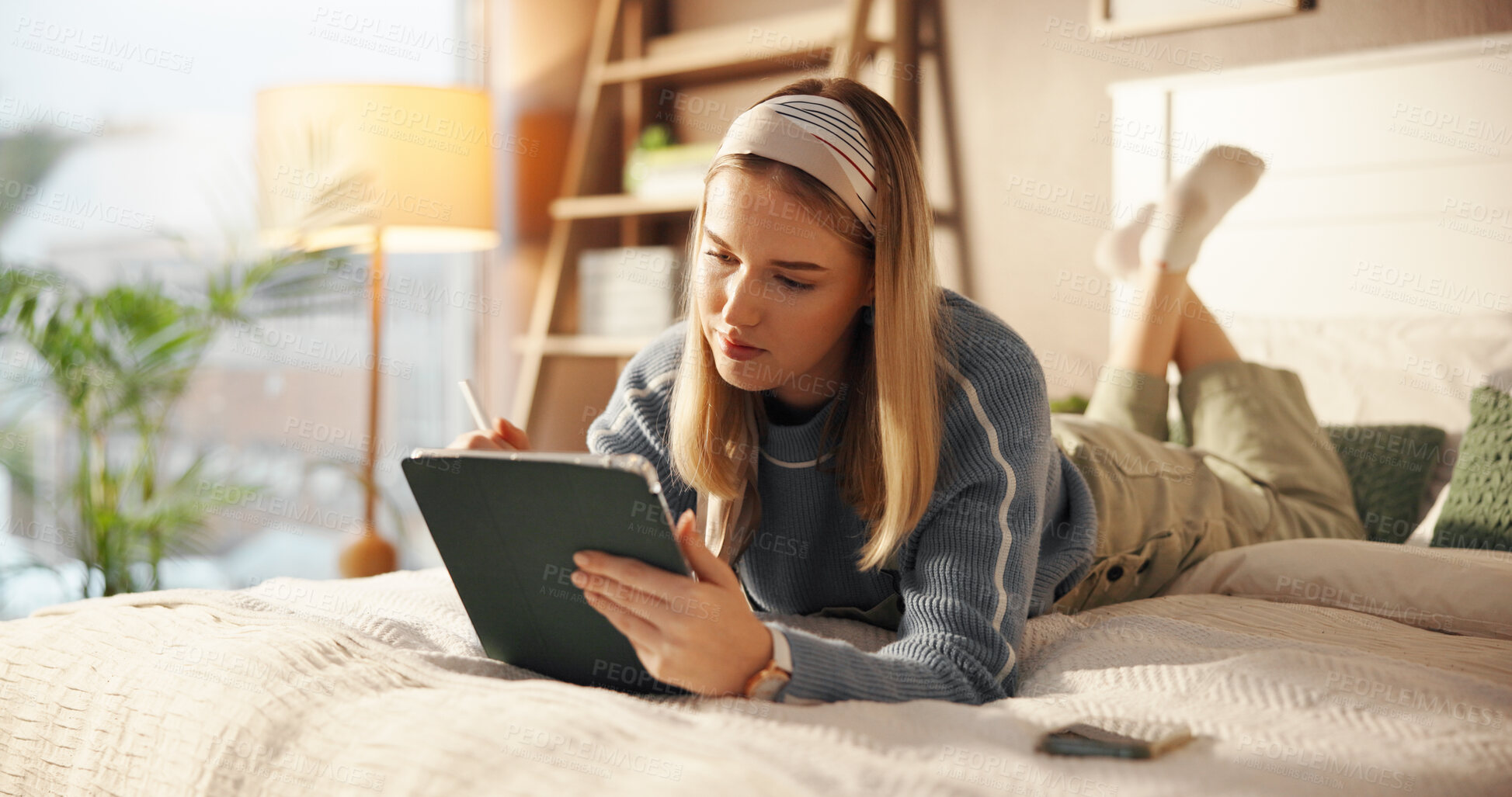 Buy stock photo Tablet, relax and woman on bed with pen for drawing, hobby or creative project on app for college. Technology, bedroom and student with stylus for graphic design assignment for university in home.