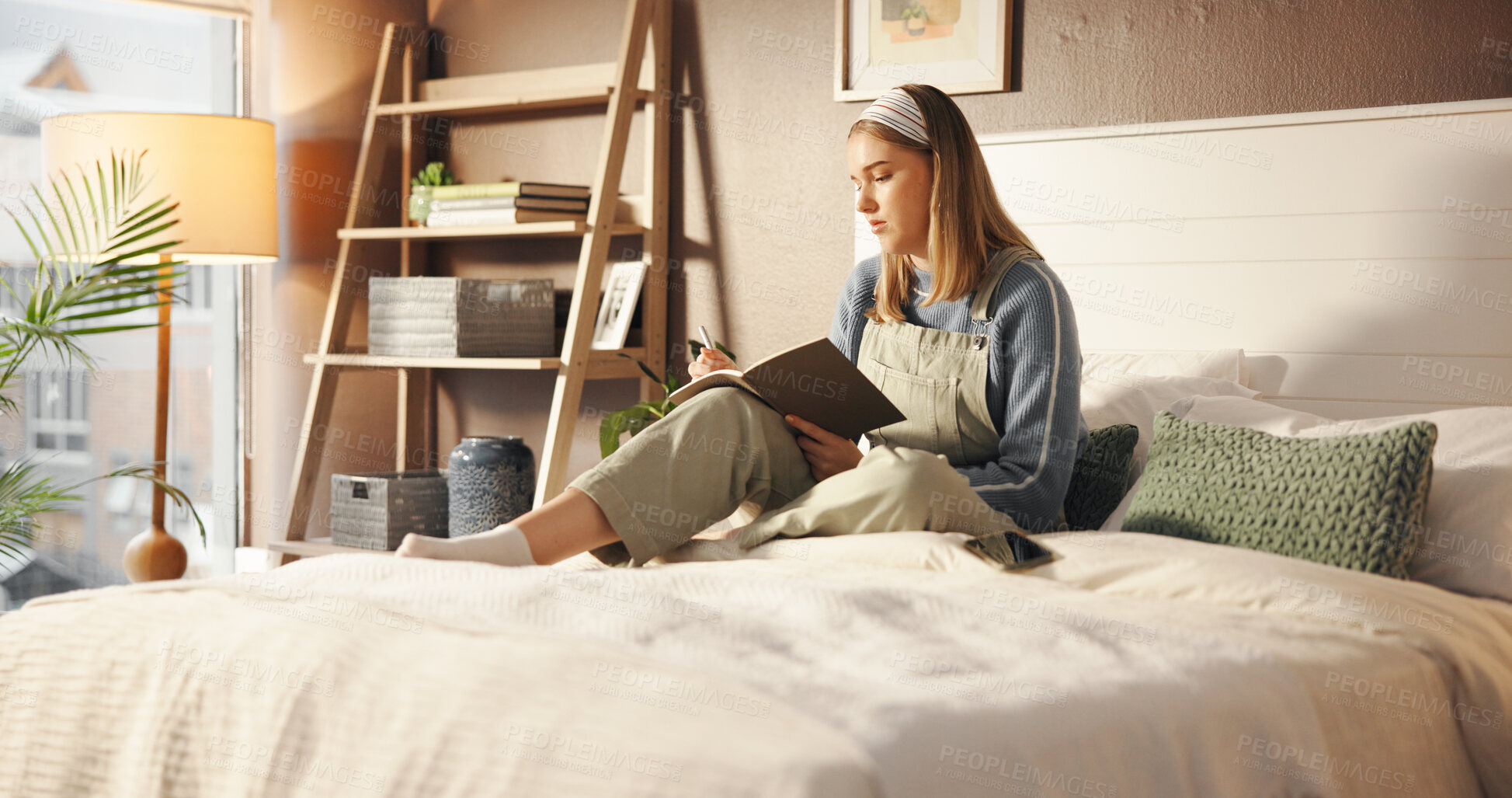 Buy stock photo Writing, notebook and relax with student in bedroom for study, assignment due date and course. University reminder, gpa progress and academic calendar with woman in home for college grades and plan