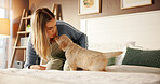 Kiss, bonding and woman with dog on bed for playing, connection or adoption in home together. Love, relax and female person with labrador puppy for pet, animal or companion in bedroom at house.